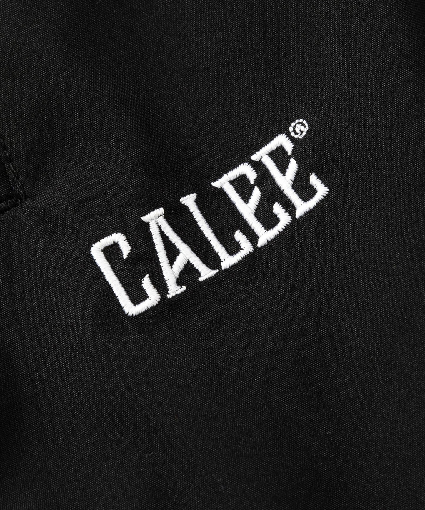 CALEE × NEW ERA/ CALEE LOGO OVERSIZED PIPING TRACK PANTS