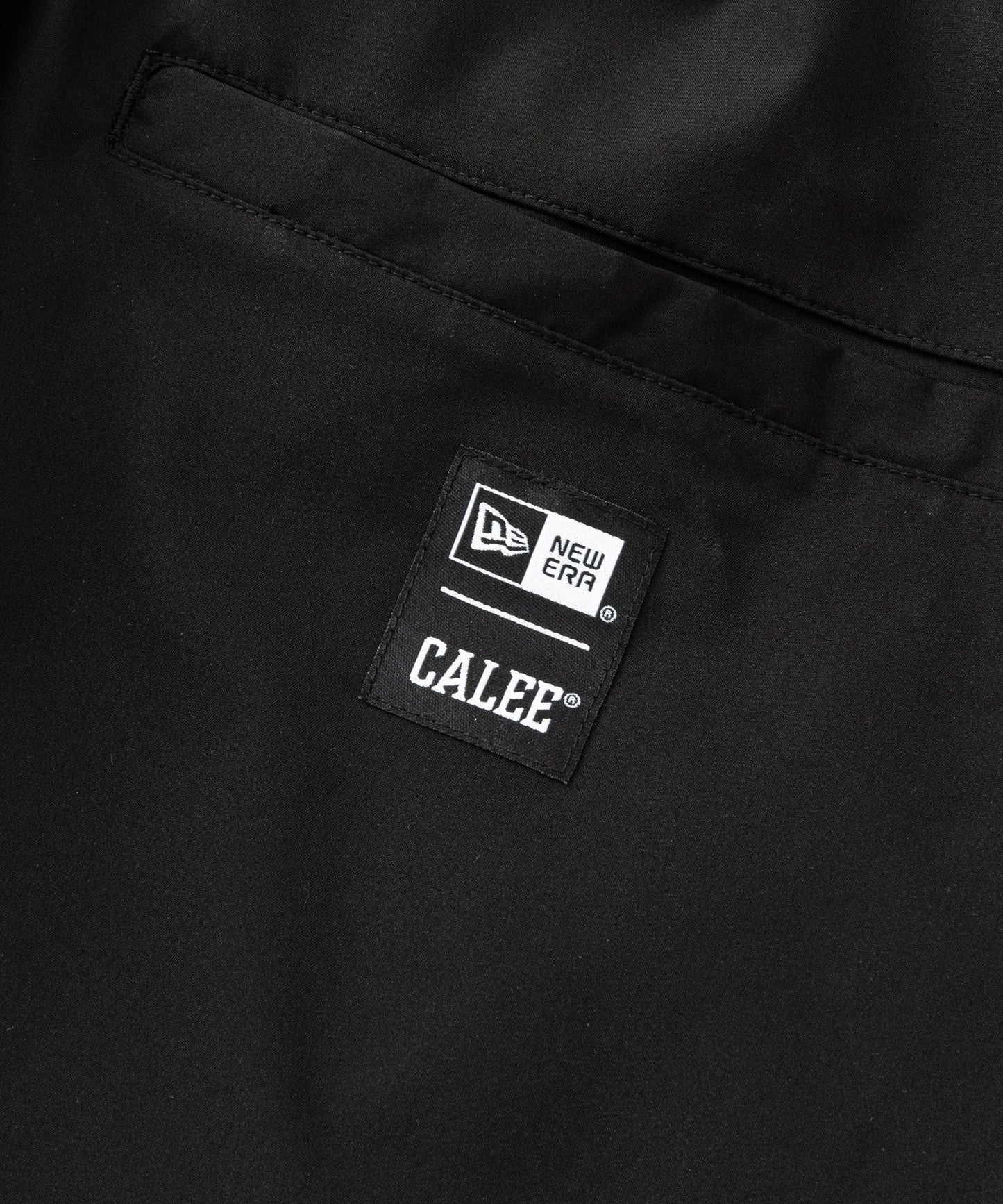 CALEE × NEW ERA/ CALEE LOGO OVERSIZED PIPING TRACK PANTS