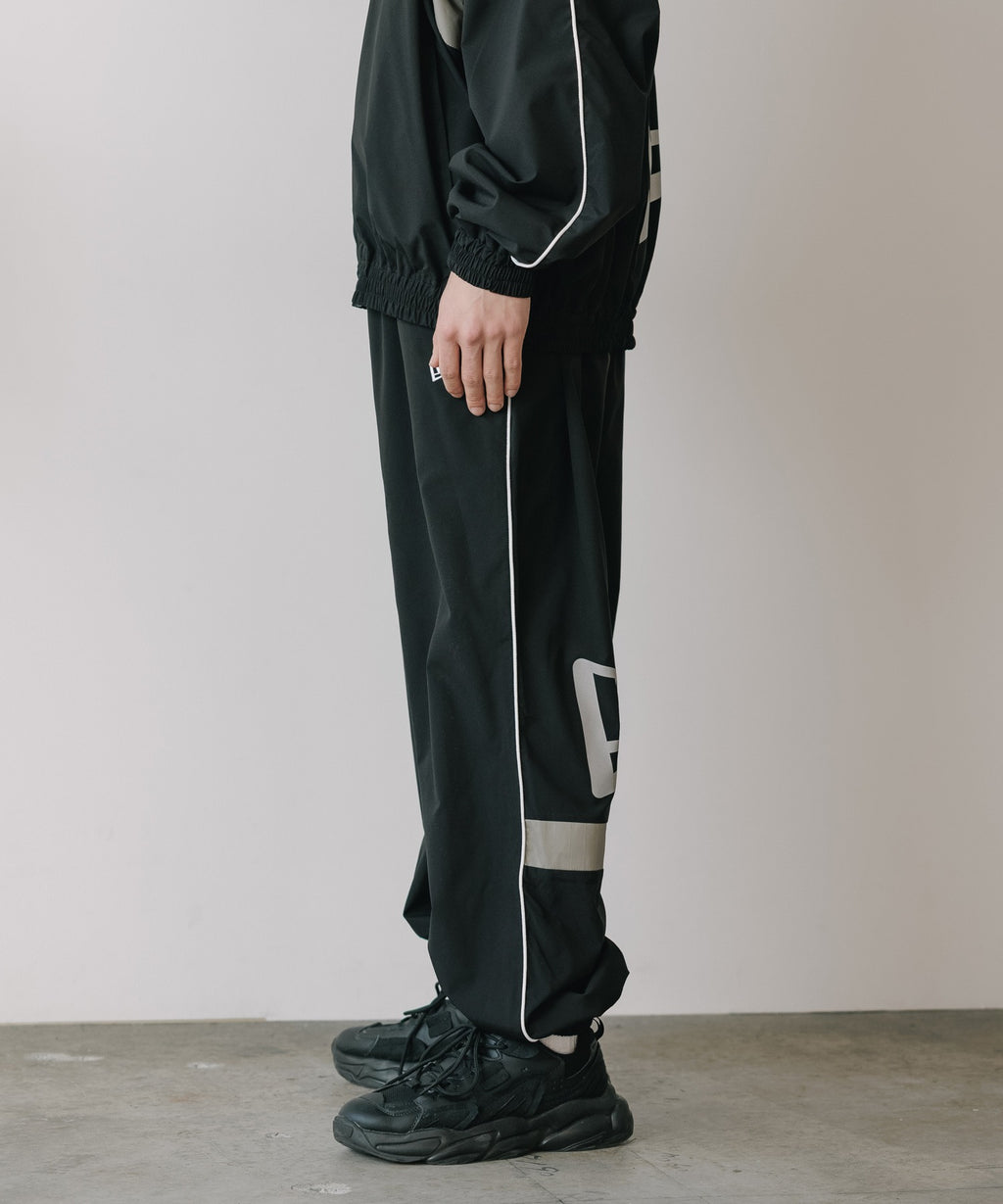 CALEE × NEW ERA/ CALEE LOGO OVERSIZED PIPING TRACK PANTS